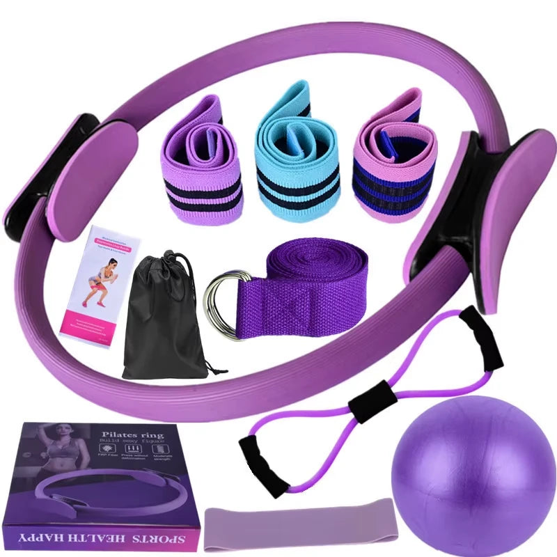Set of Purple exercise equipment including a Pilates ring, resistance bands, and a ball on a white background.