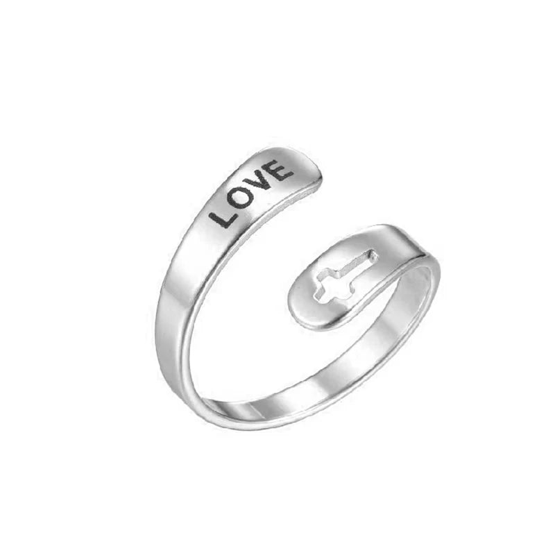 Silver ring with 'LOVE' laser etched on, on a white background