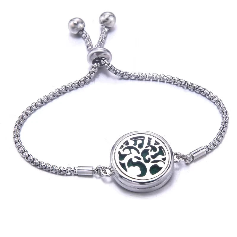 Silver bracelet with a round pendant featuring a floral design on a white background