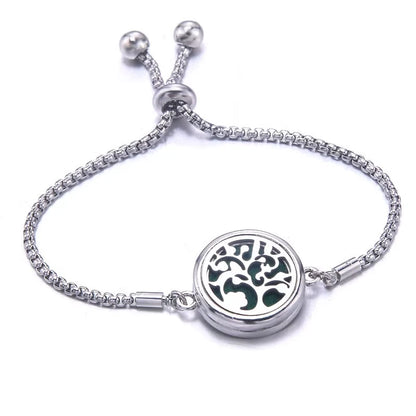 Silver bracelet with a round pendant featuring a floral design on a white background