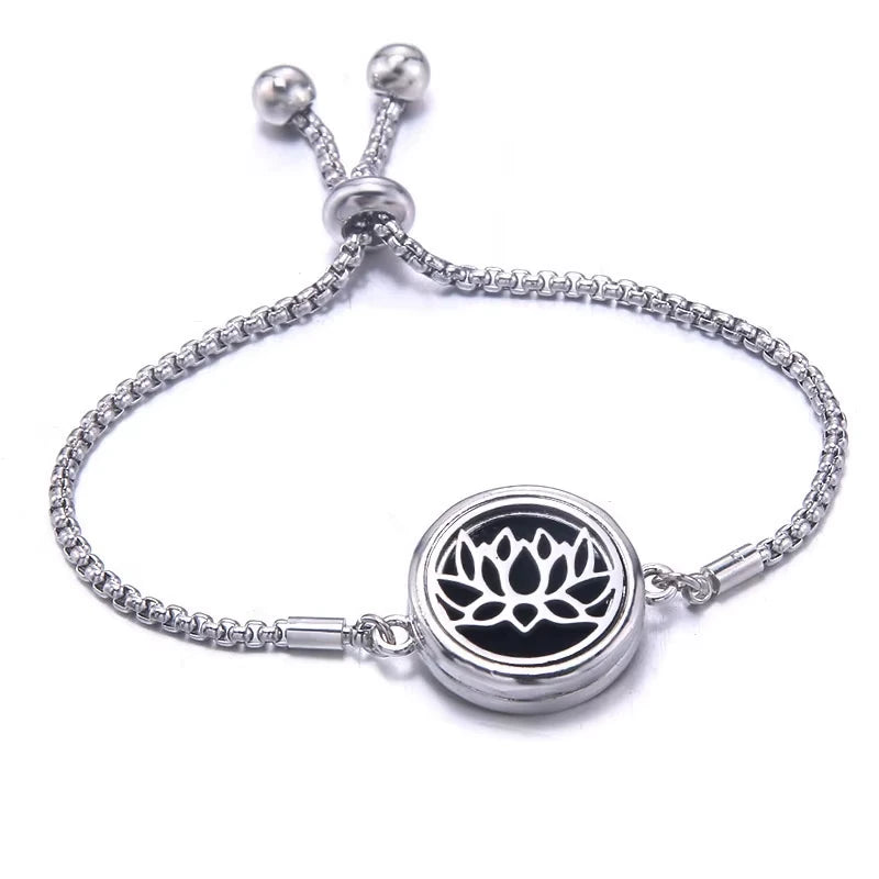 Silver bracelet with a black pad featuring a lotus lily design on a white background