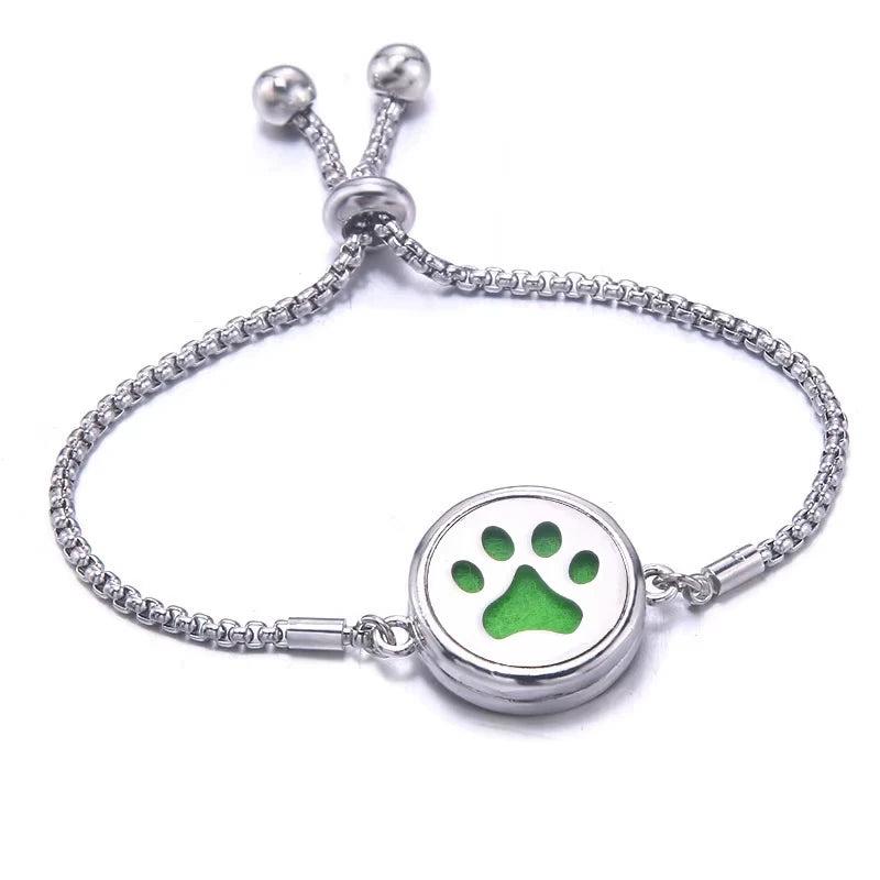 Bracelet with a green pad and paw print design on a white background