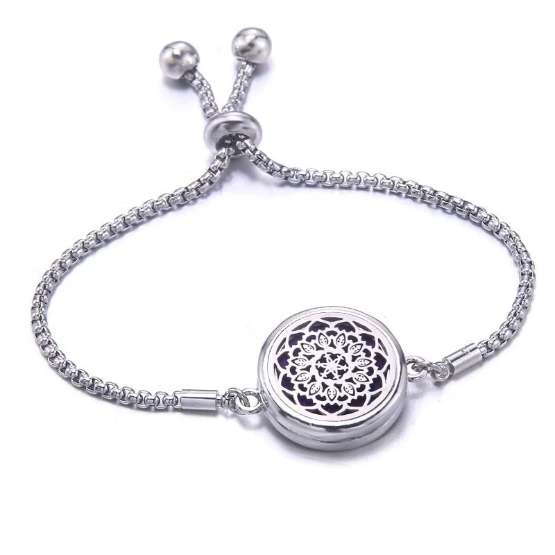 Silver bracelet with a purple pad featuring a floral design on a white background