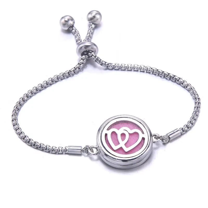 Silver bracelet with a pink pad featuring a dual heart design on a white background