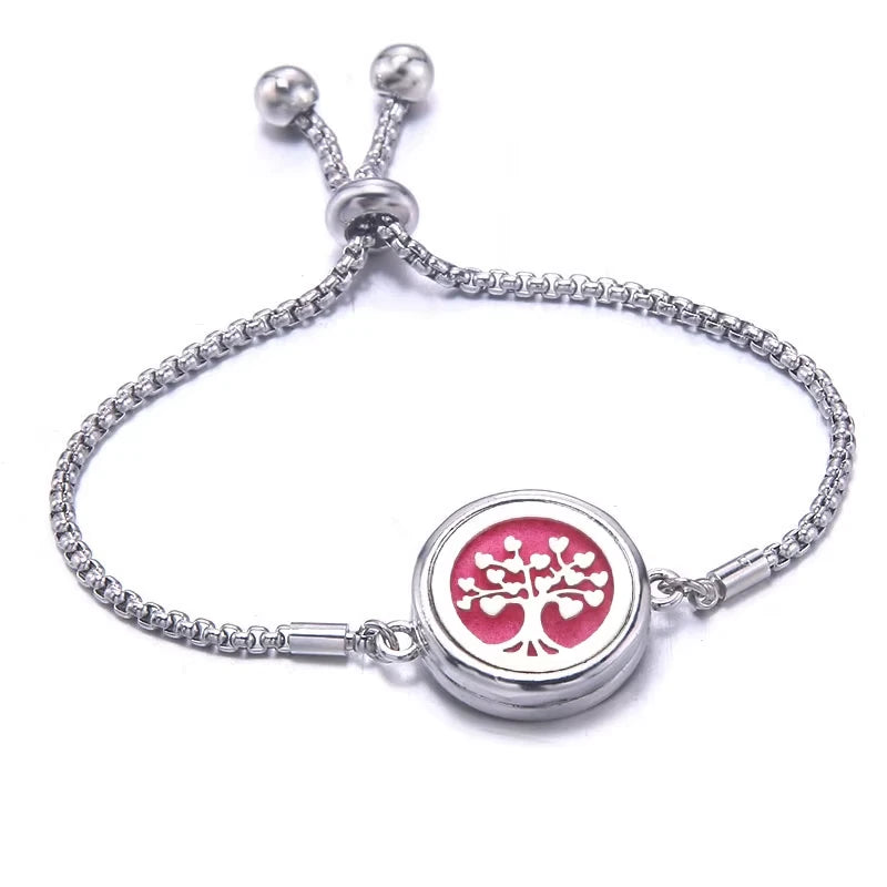 Silver bracelet with a pink pad featuring tree-of-life design on a white background