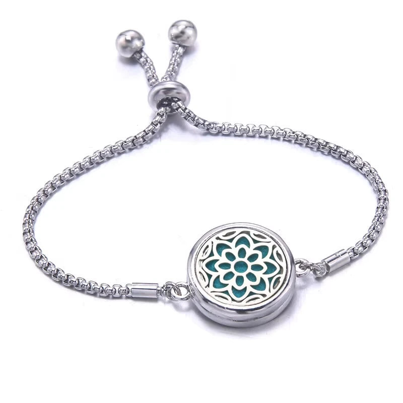 Silver bracelet with a light blue pad featuring a floral design on a white background