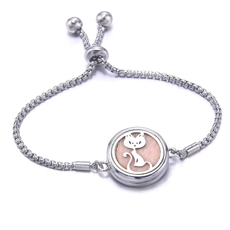 Silver bracelet with a pink pad featuring a cat design on a white background