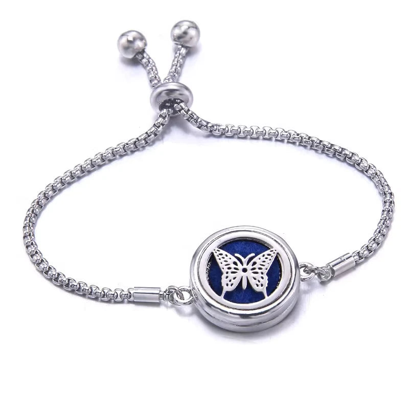 Silver bracelet with a blue pad featuring a small butterfly design on a white background