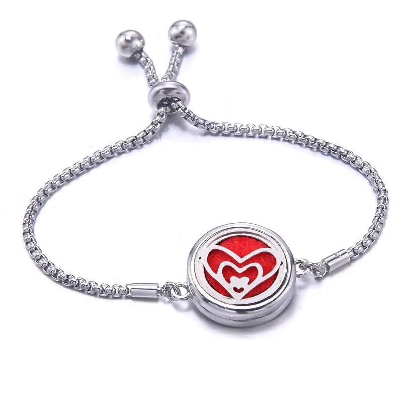 Silver bracelet with a red pad featuring a beating heart-shaped design on a white background