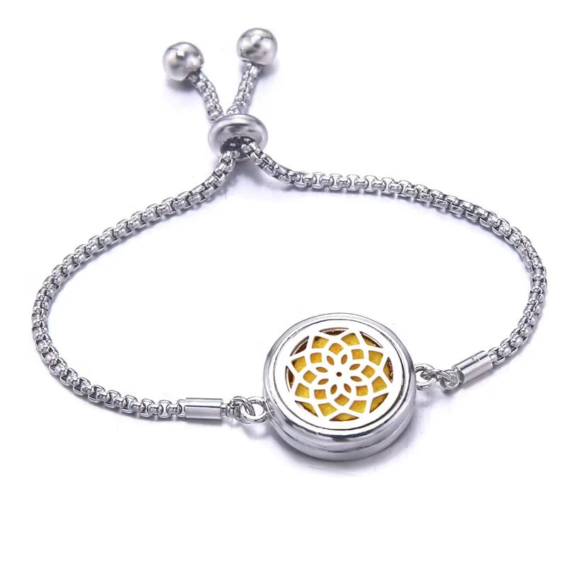 Silver bracelet with a yellow pad featuring a floral design on a white background