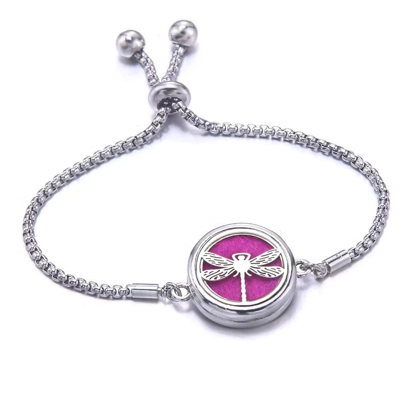 Silver bracelet with a pink pad featuring a dragonfly design on a white background