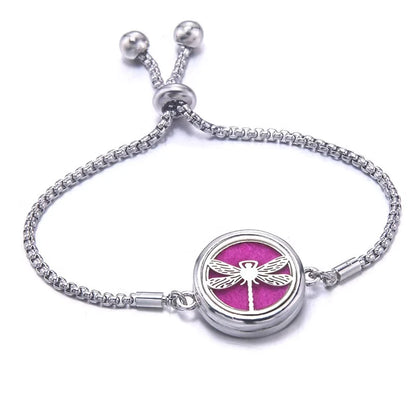Silver bracelet with a pink pad featuring a dragonfly design on a white background