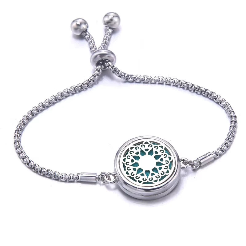 Silver bracelet with a circular locket on a white background