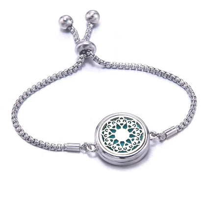Silver bracelet with a circular locket on a white background