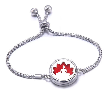 Silver bracelet with a red pad featuring a lotus design on a white background