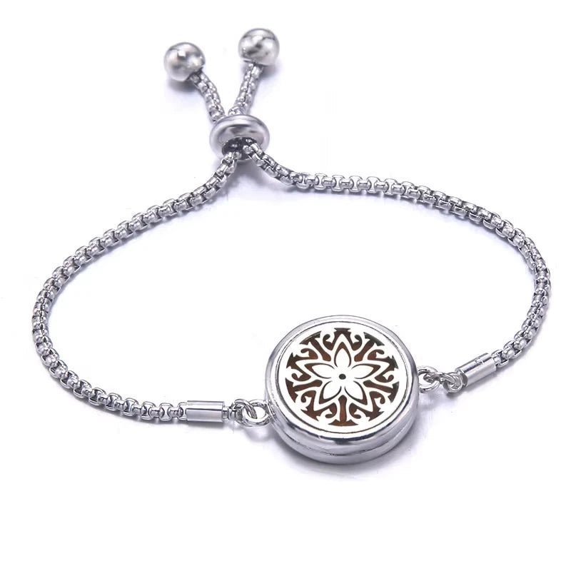 Silver bracelet with a floral design on a white background