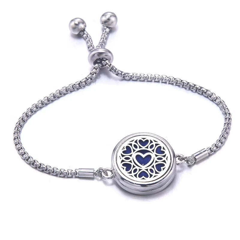 Silver bracelet with a blue pad featuring a heart-shaped design on a white background