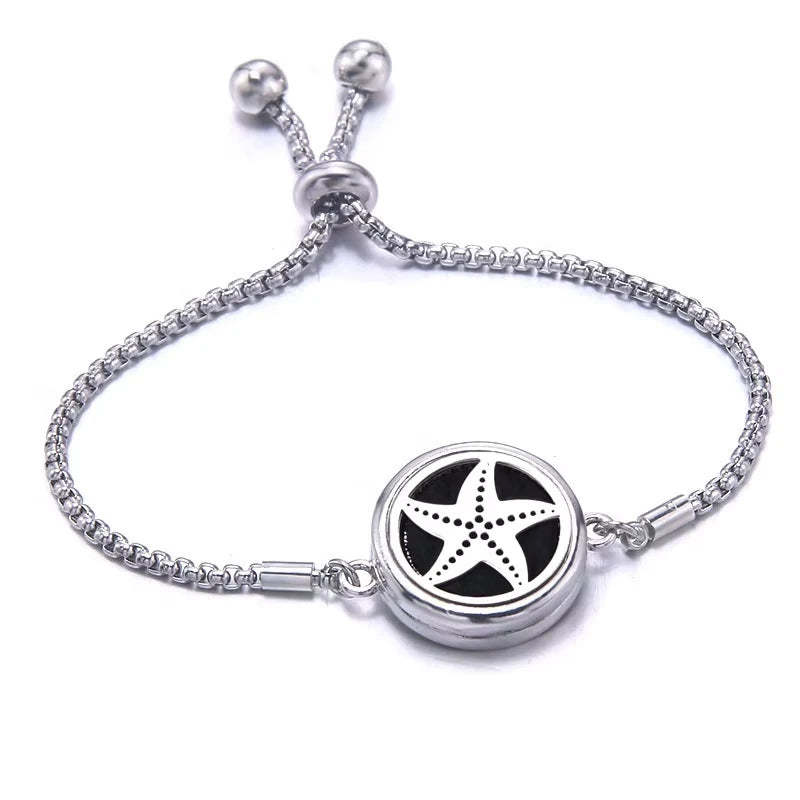 Silver bracelet with a black pad featuring a star fish design on a white background