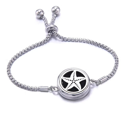 Silver bracelet with a black pad featuring a star fish design on a white background