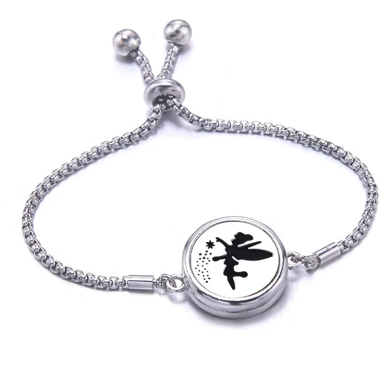 Silver bracelet  with a black pad featuring a pixie design on a white background