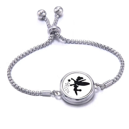 Silver bracelet  with a black pad featuring a pixie design on a white background