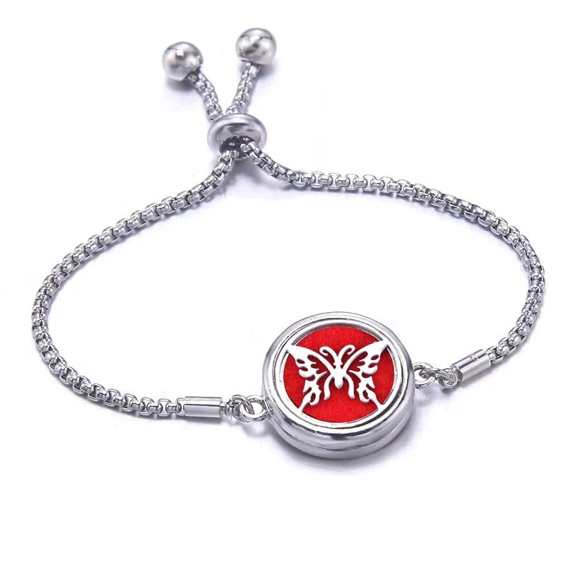 Silver bracelet with a red pad featuring a butterfly design on a white background