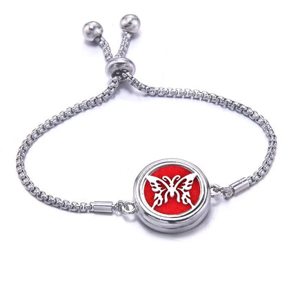 Silver bracelet with a red pad featuring a butterfly design on a white background