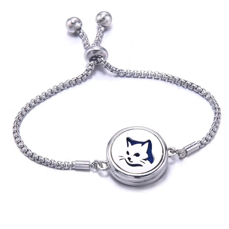 Silver bracelet with a blue pad featuring a cat face  on a white background