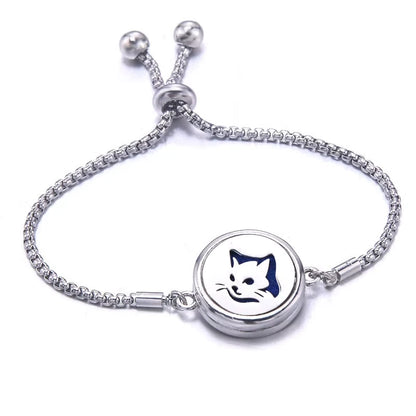 Silver bracelet with a blue pad featuring a cat face  on a white background