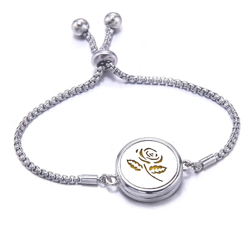 Silver bracelet with a yellow pad featuring a rose design on a white background
