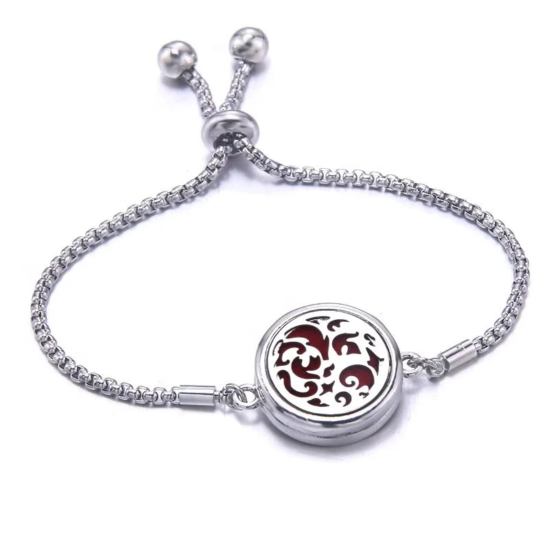 Silver bracelet with a red pad featuring a floral design on a white background