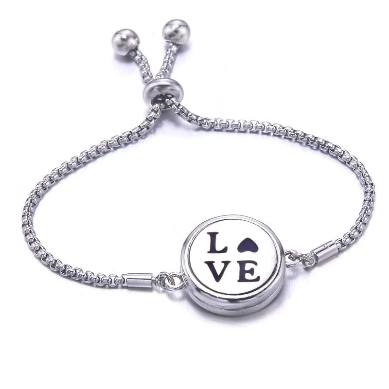 Silver bracelet with a purple pad featuring a round charm displaying the word 'LOVE' on a white background