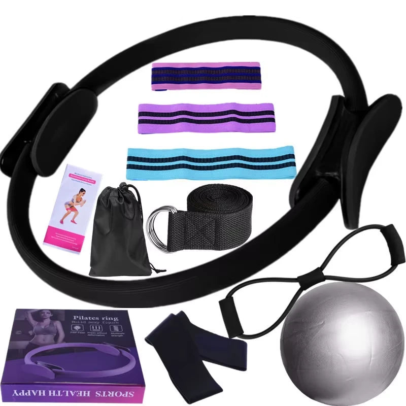 Set of black exercise equipment including a Pilates ring, resistance bands, and a ball on a white background.