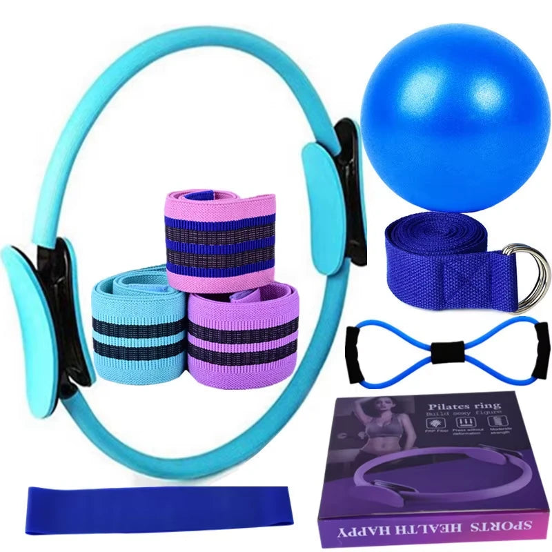 Set of blue exercise equipment including a Pilates ring, resistance bands, and a ball on a white background.