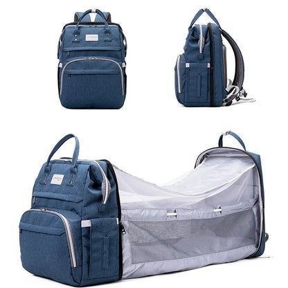 Blue backpack and a baby changing bag attachment on a white background