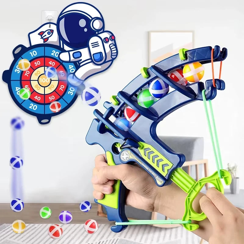 showing toy bow with colorful sticky balls being launched at target board on the wall in the background.