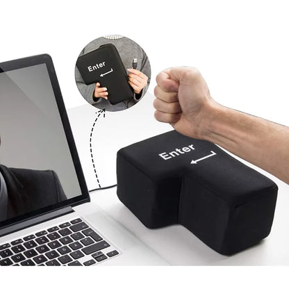 Black Big 'Enter' key with a fist above it, placed on a desk next to a laptop showing an insert of hands holding it and showing the connector.