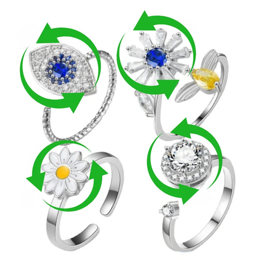 Set of four silver rings with gemstones and floral designs showing the spinning feature on a white background