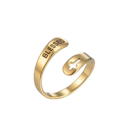 Gold ring with 'BLESSED' laser etched on, on a white background