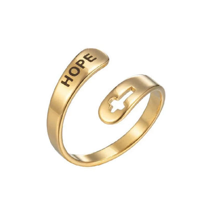 Gold ring with 'HOPE' laser etched on, on a white background
