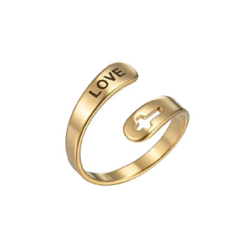 Gold ring with 'LOVE' laser etched on, on a white background