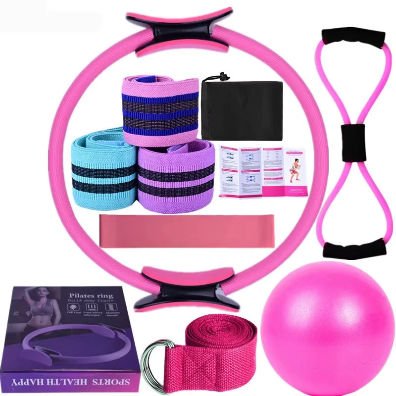 Set of Pink exercise equipment including a Pilates ring, resistance bands, and a ball on a white background.
