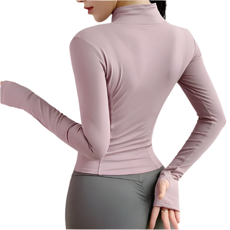 Back side and arm of a woman wearing a pink zip up thumb hole jacket and gray leggings showing the hand with thumb hole against a white background 