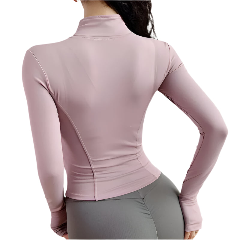Woman wearing a pink zip up thumb hole jacket and gray leggings back view against a white background 