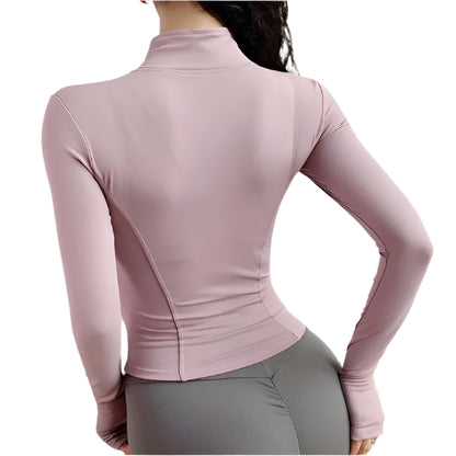 Woman wearing a pink zip up thumb hole jacket and gray leggings back view against a white background 