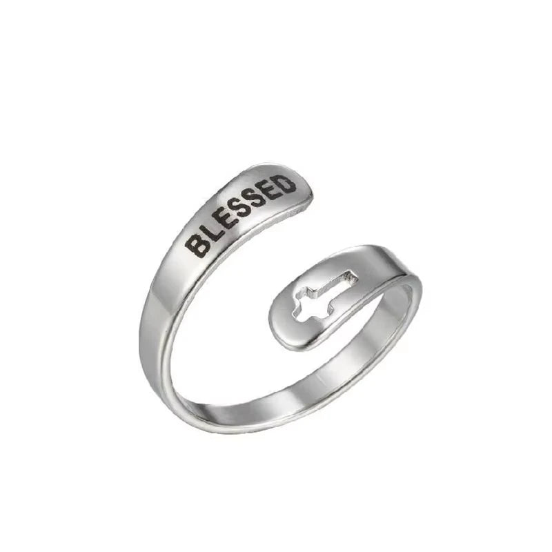 Silver ring with 'BLESSED' laser etched on, on a white background