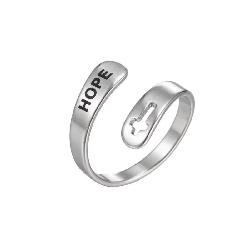Silver ring with 'HOPE' laser etched on, and cross design on a white background