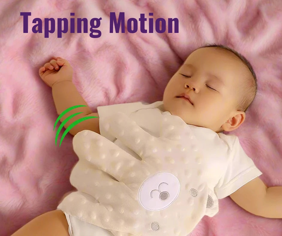 Baby sleeping on a pink blanket with the HushHand on its tummy indicating the 'Tapping Motion' as labeled