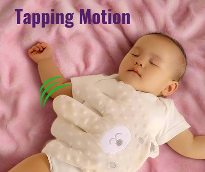 Baby sleeping on a pink blanket with the HushHand on its tummy indicating the 'Tapping Motion' as labeled