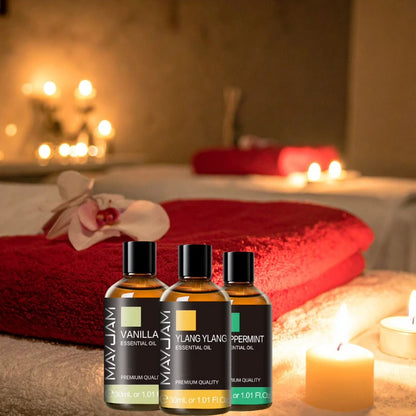 Essential oil bottles with candles and red towels in a spa setting